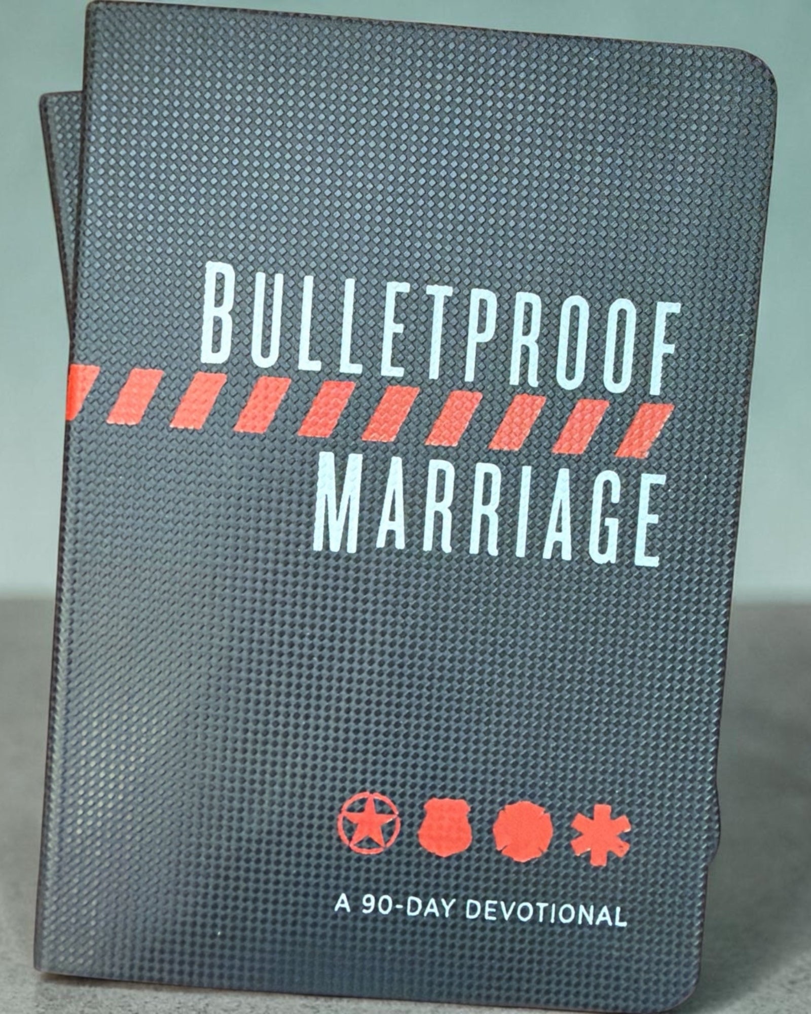 Black Bulletproof Marriage 90-Day Devotional with white and red cover lettering