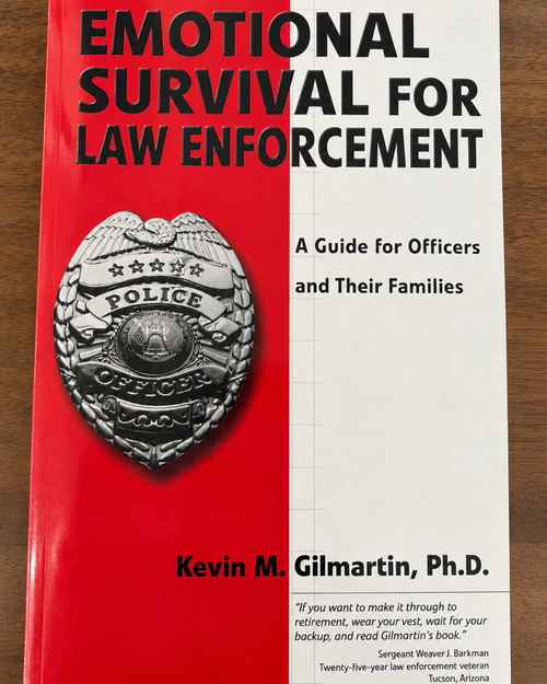 Paperback cover of Emotional Survival for Law Enforcement by Kevin M. Gilmartin, a guide for officers and their families on hypervigilance, stress, and emotional wellness.